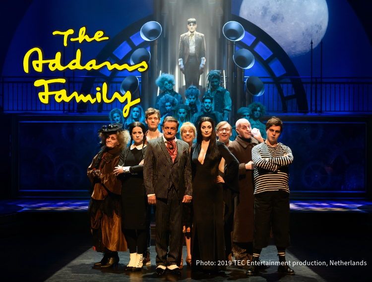 The Addams Family Musical, the cast on stage in theatrical lighting